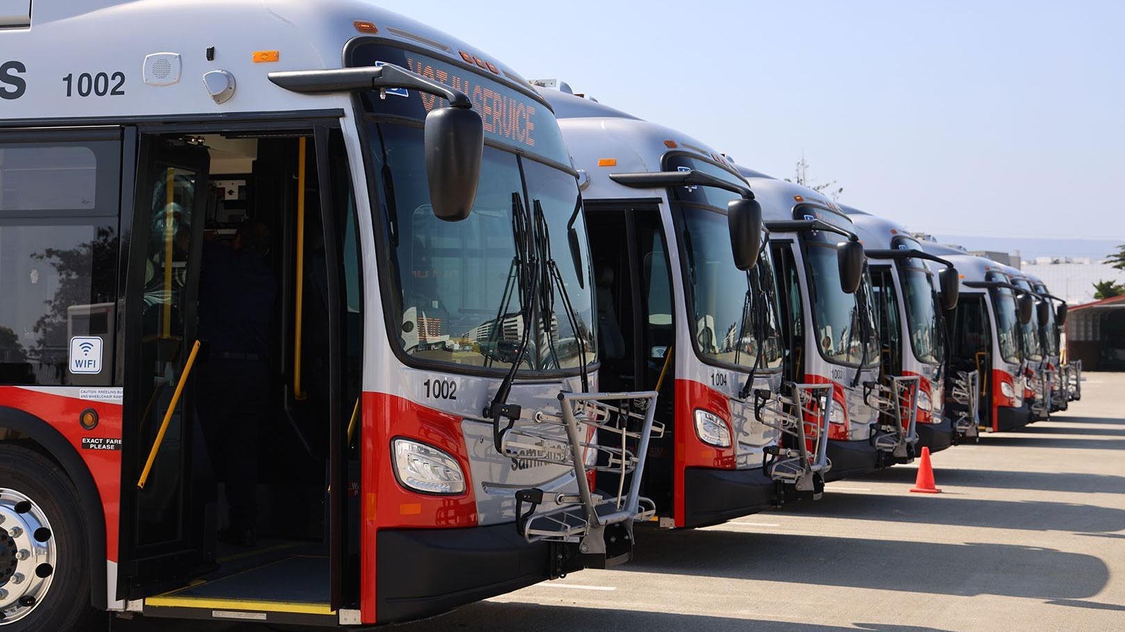 A line of SamTrans buses sits in waiting.