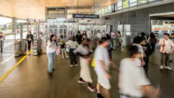 Riders enter a transit station. Riders enter a transit station.