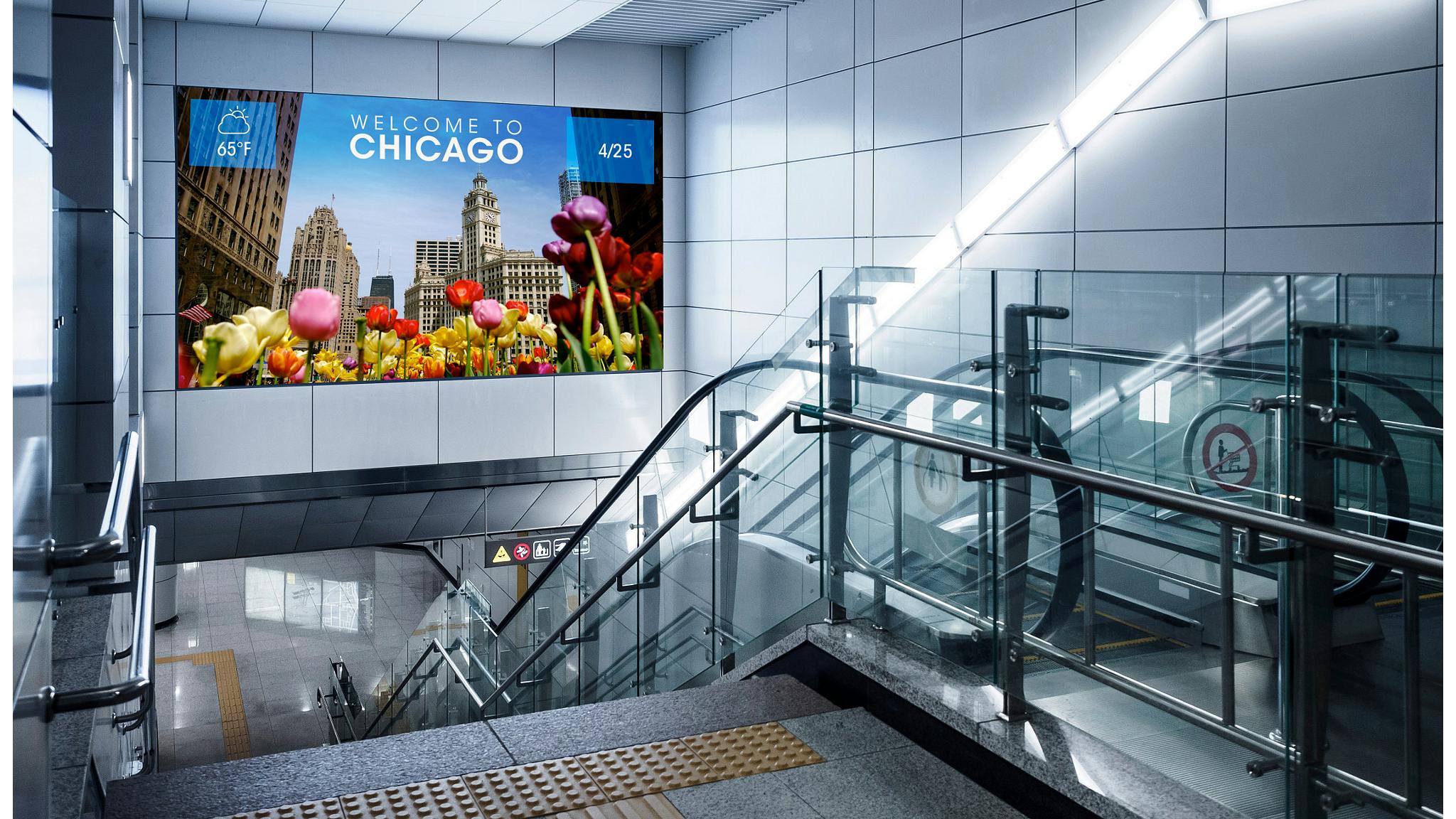 The image shows the SEAMLESS dvLED Video Wall showing the date and weather layered over an image of flowers in the foreground of a cityscape and text saying 'Welcome to Chicago.'