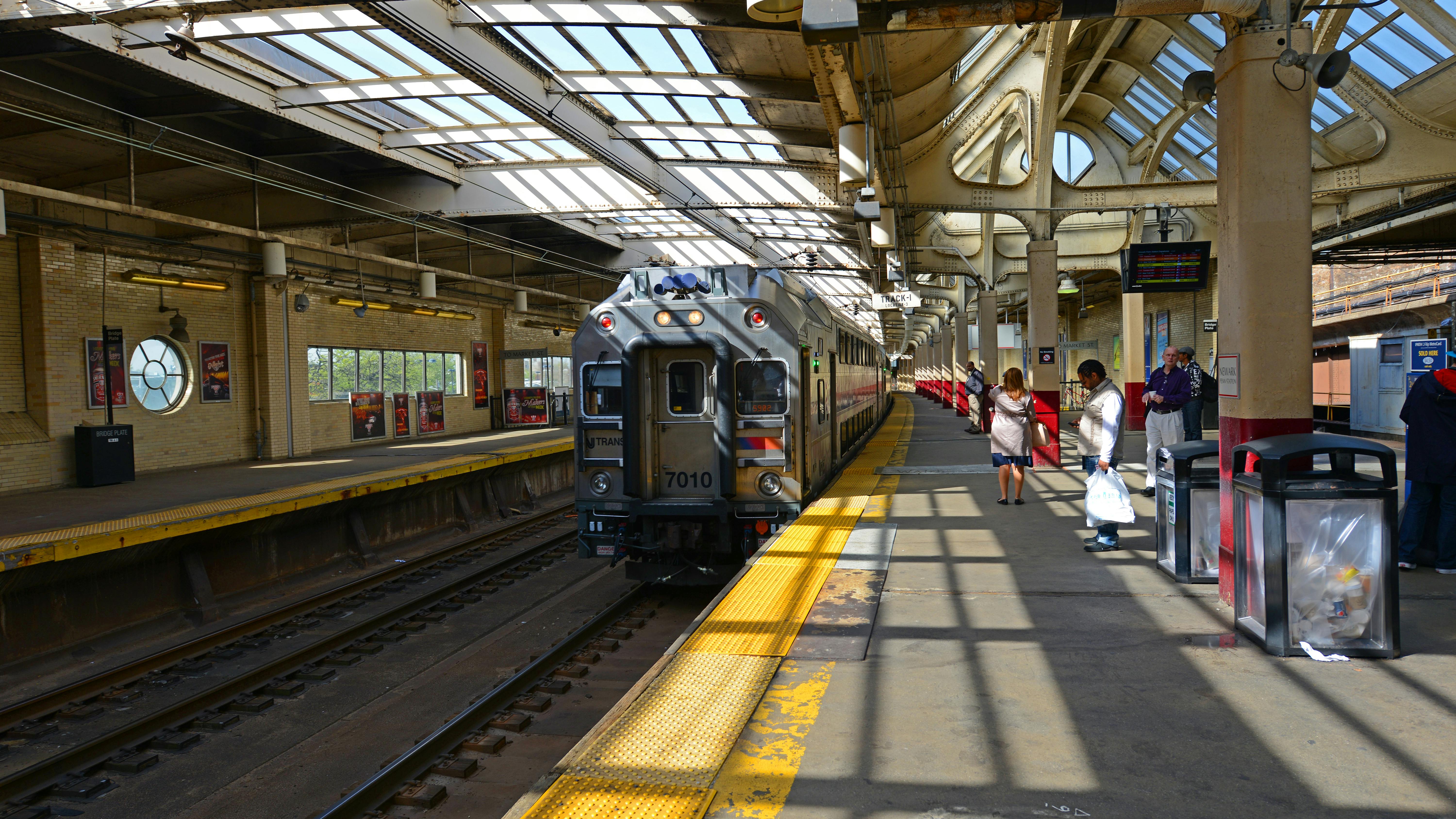 The image shows an existing multilevel car pulling out of the station.