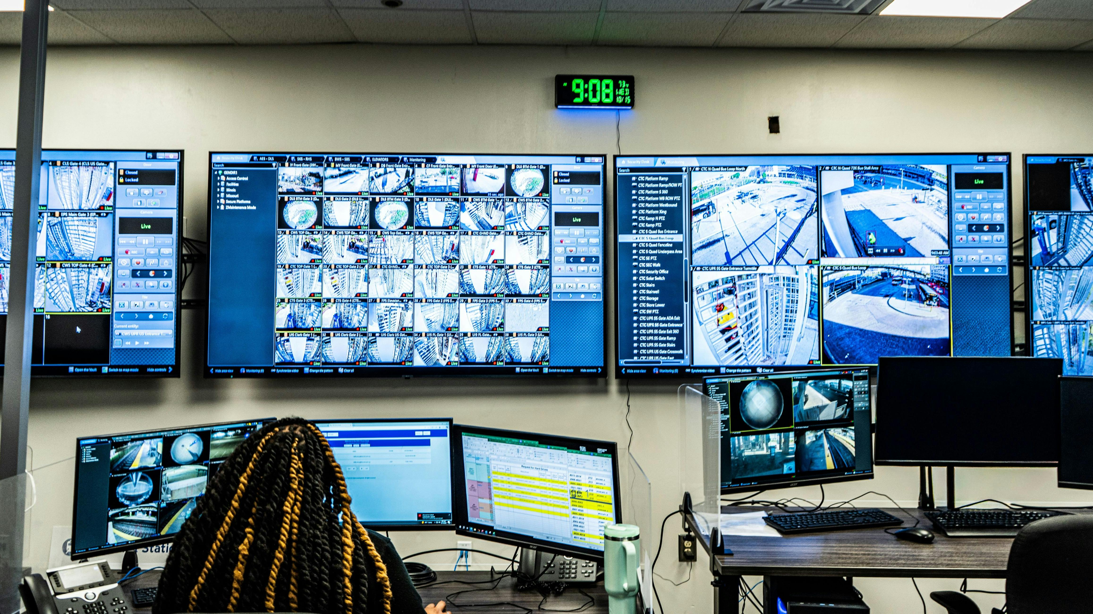 A security agent watches the real-time camera feeds at the real-time camera center.
