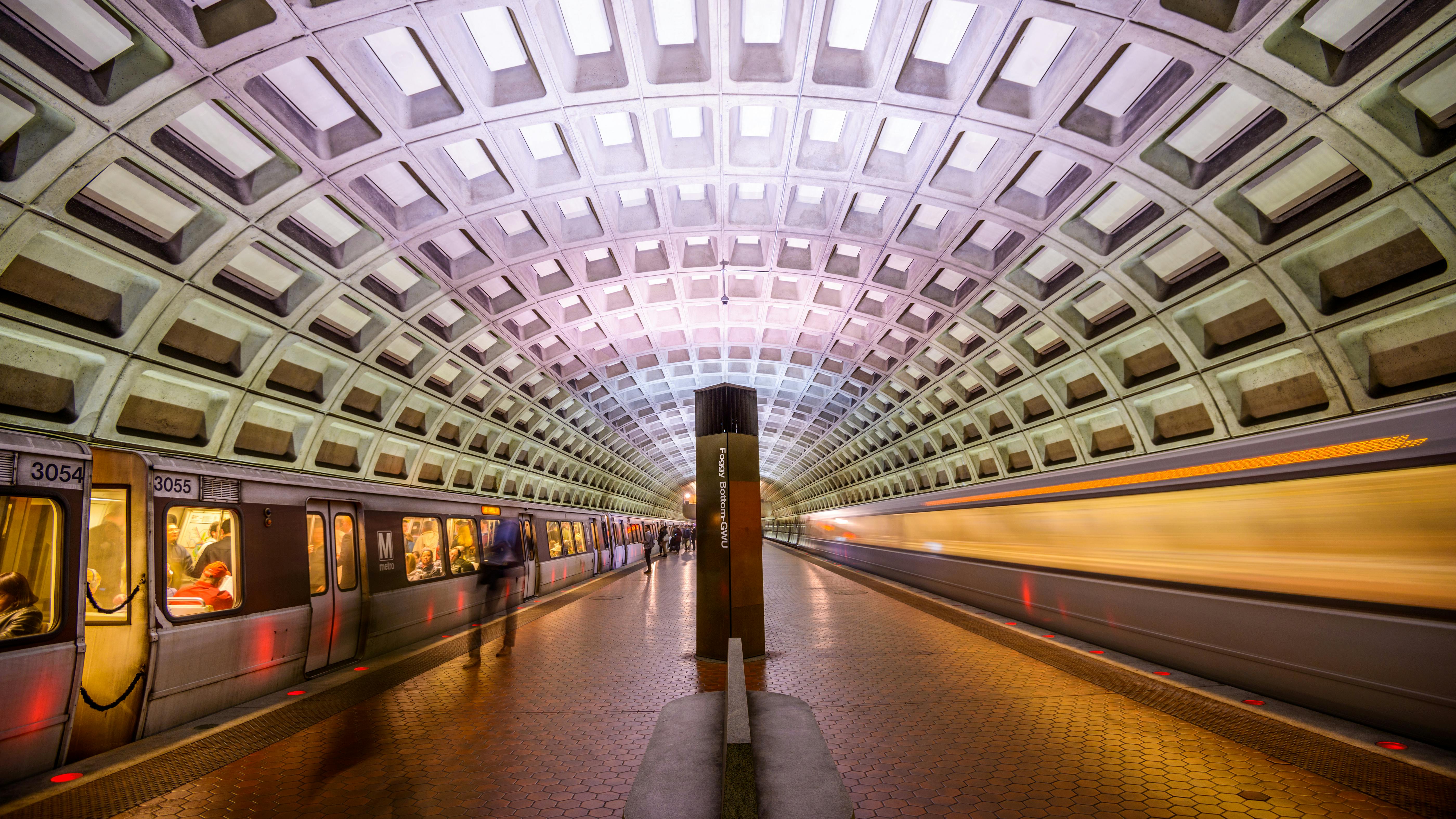 WMATA trains pass through a station.