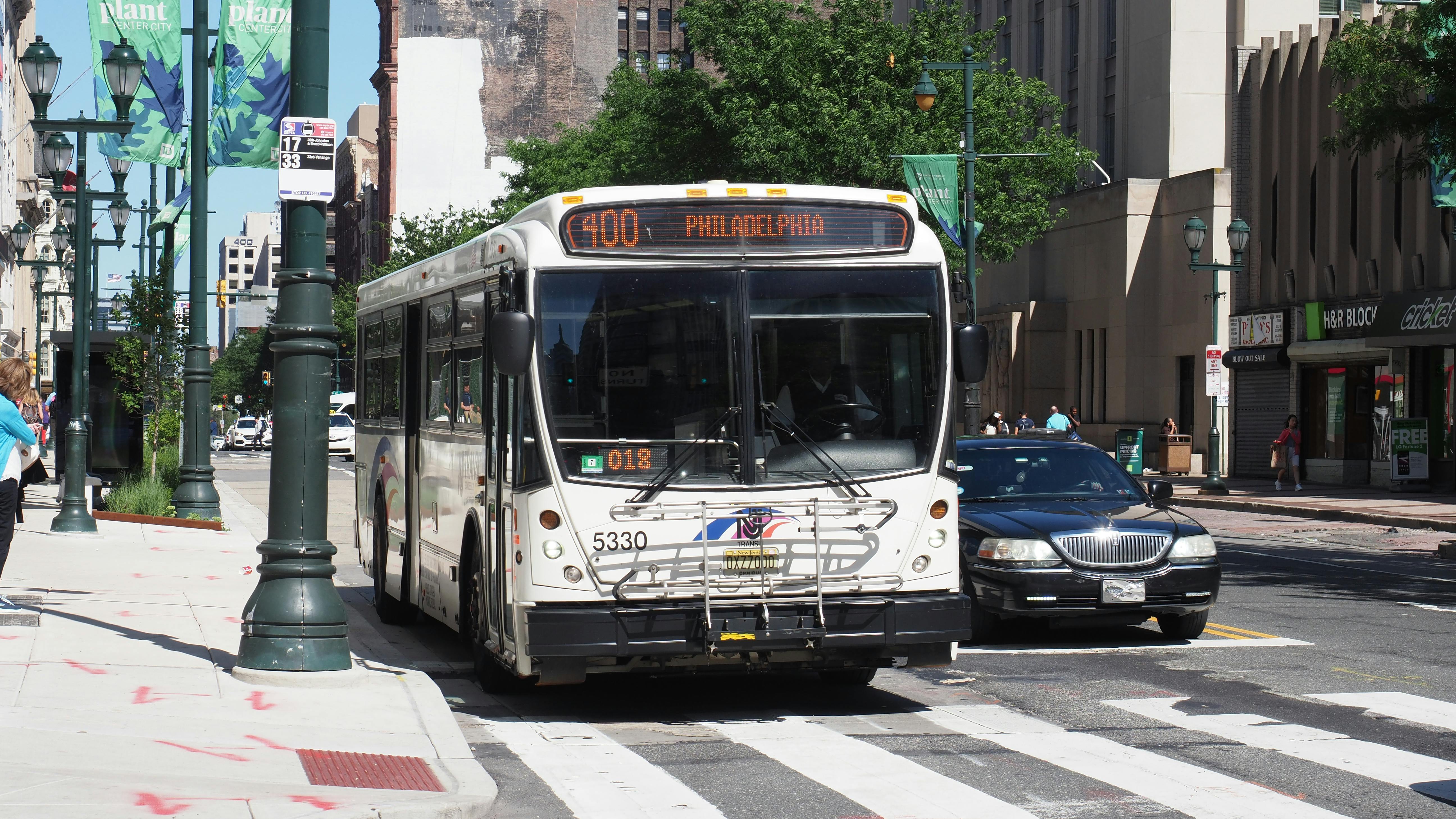 A NJ Transit bus drives down the street.