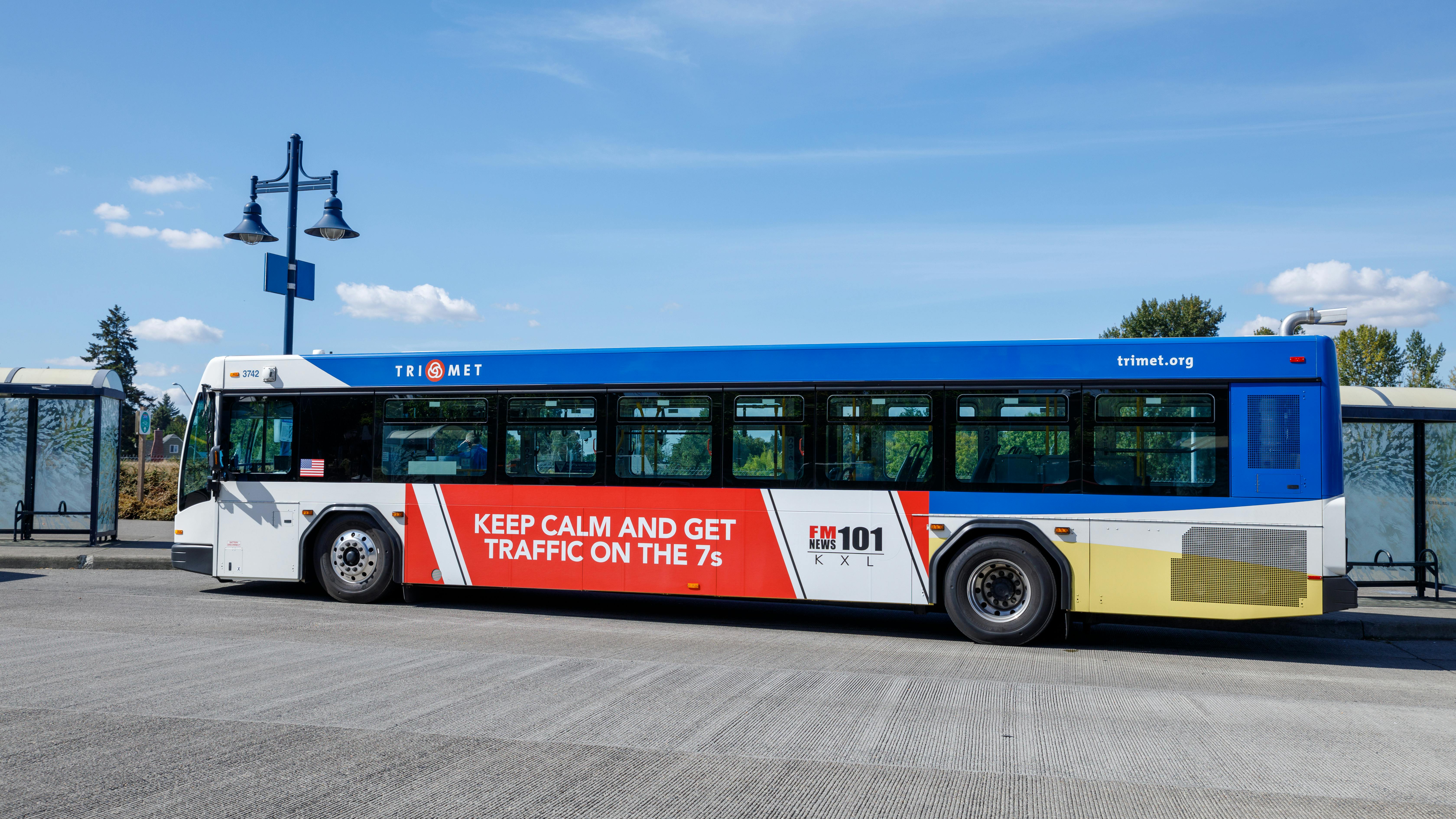 A TriMet bus approaches a stop.
