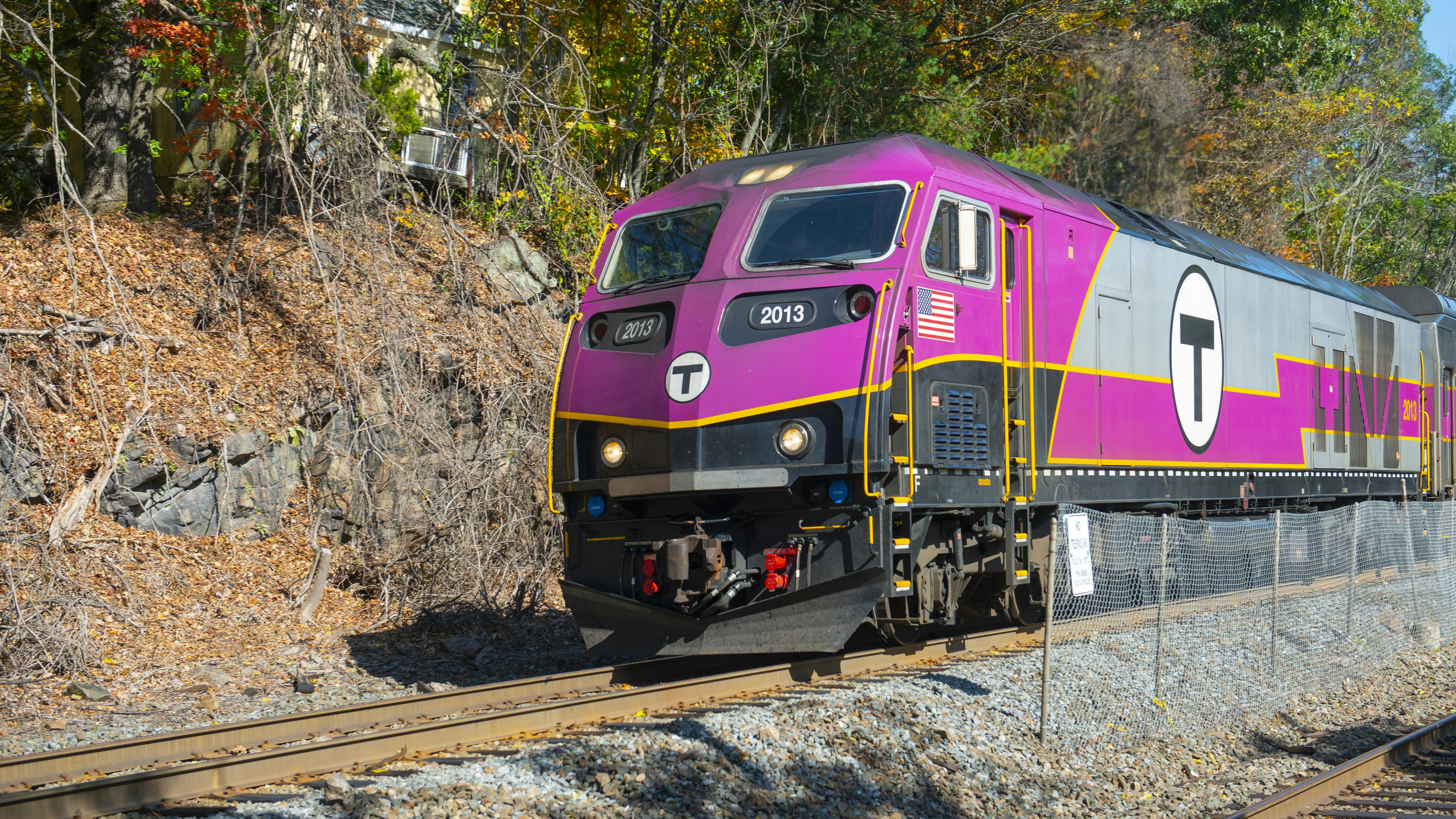 An MBTA Commuter Rail trains moves along the track.