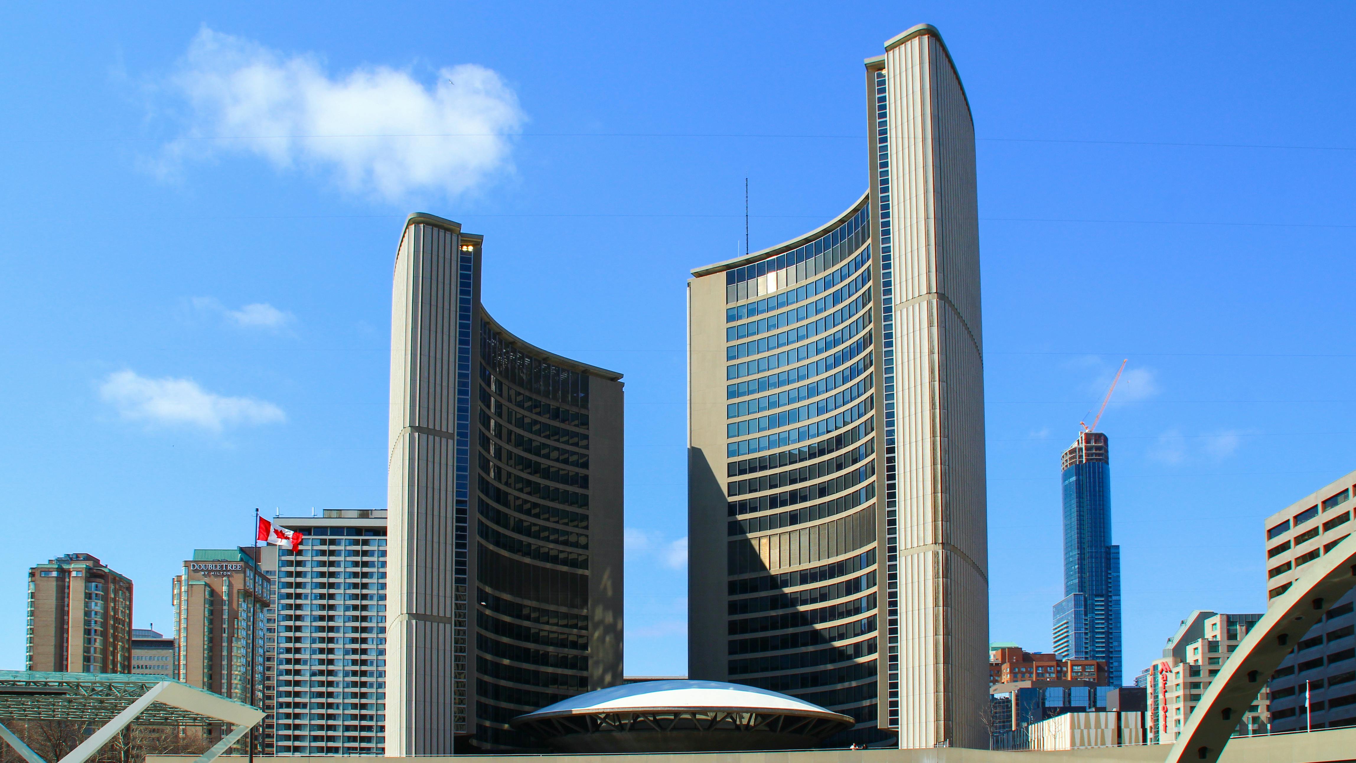 The image shows Toronto City Hall.
