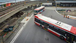 The image shows two TTC buses entering a transit center. The image shows two TTC buses entering a transit center.