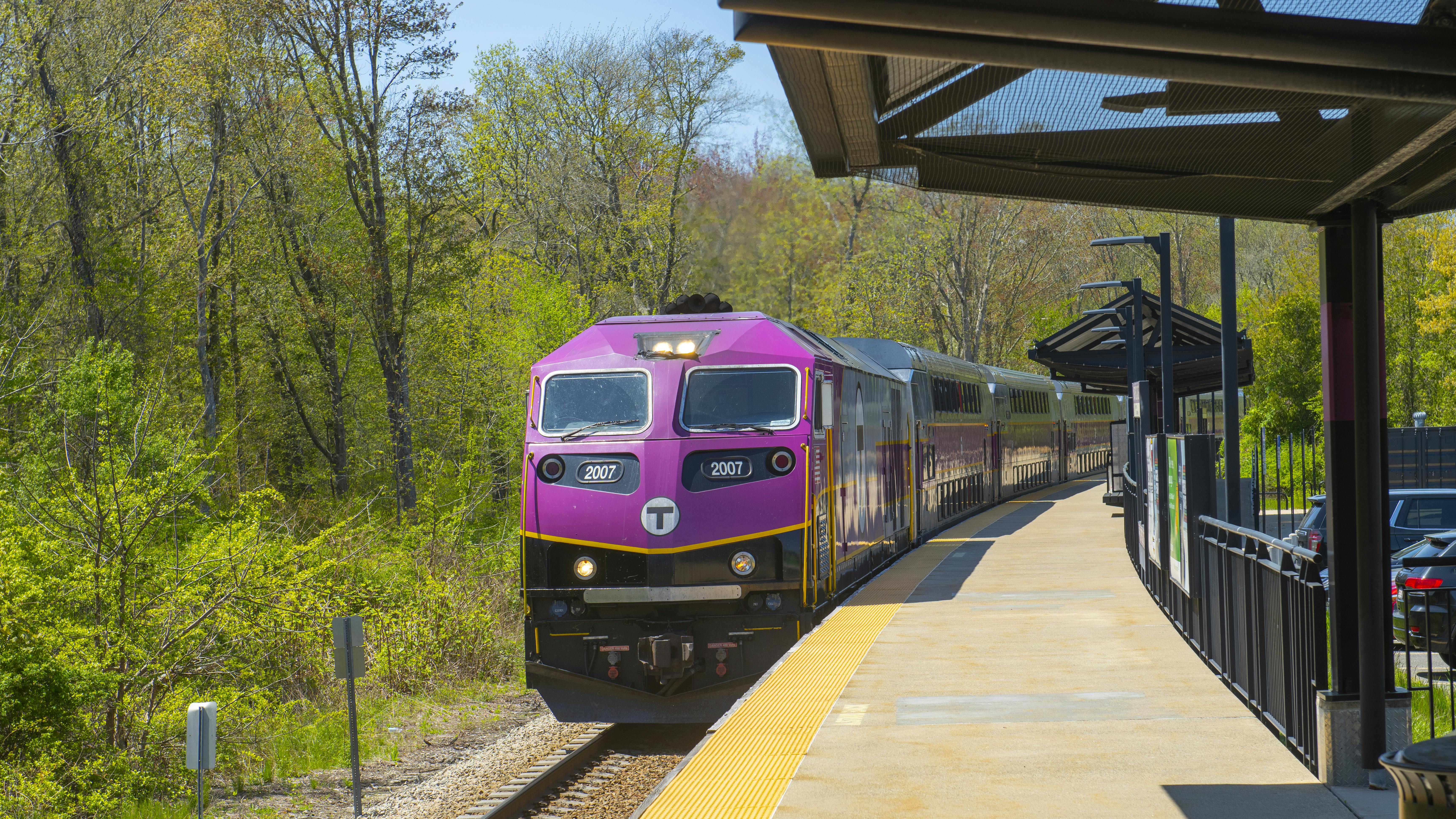 An MBTA commuter train stops at a station.