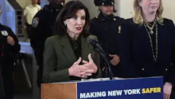 New York Gov. Kathy Hochul stands at a lectern speaking. New York Gov. Kathy Hochul stands at a lectern speaking.