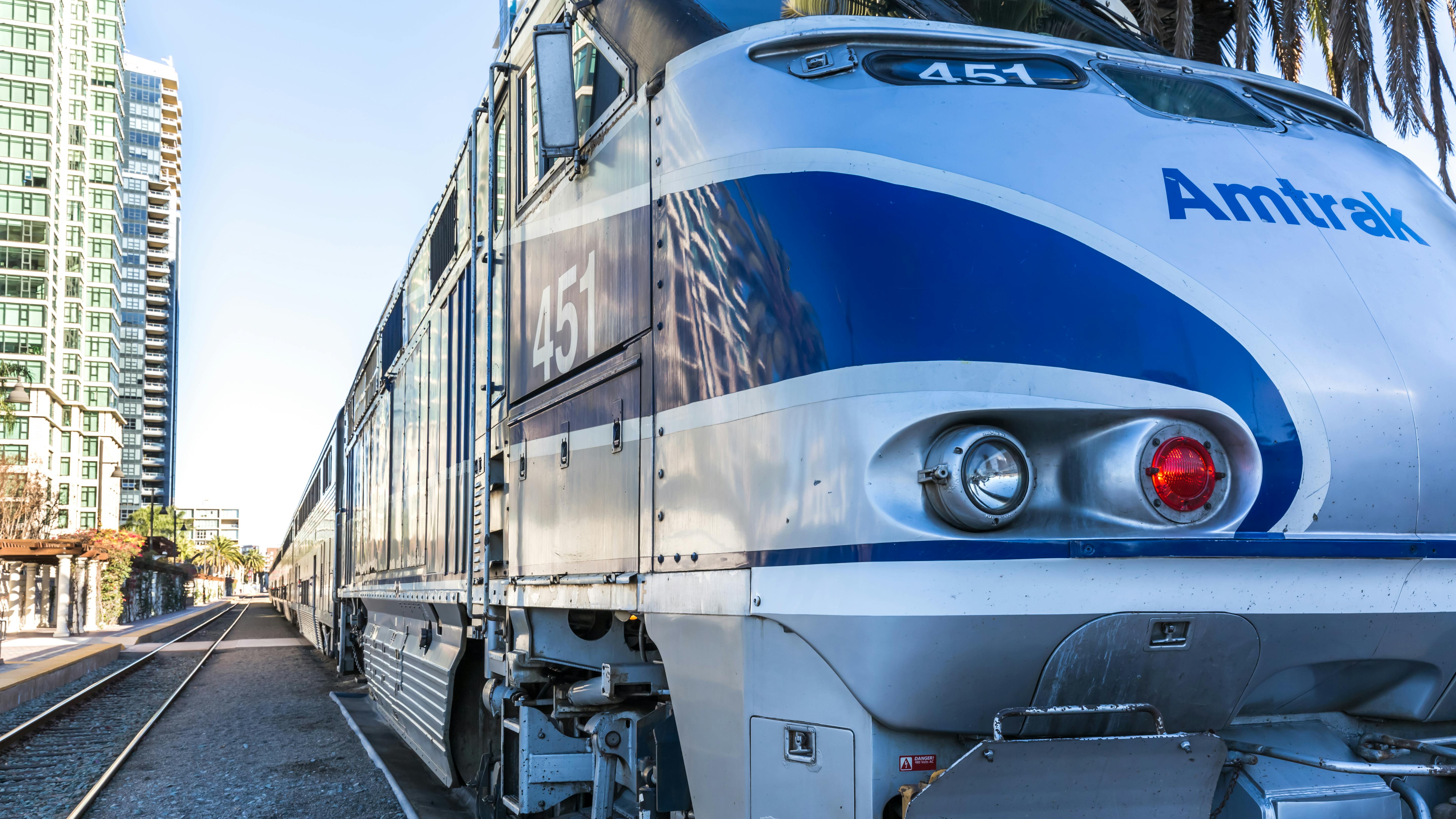 An Amtrak train waits to exit a station.
