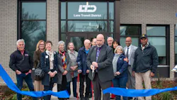 Local leaders stand behind a blue ribbon being cut in front of the operations command center. Local leaders stand behind a blue ribbon being cut in front of the operations command center.