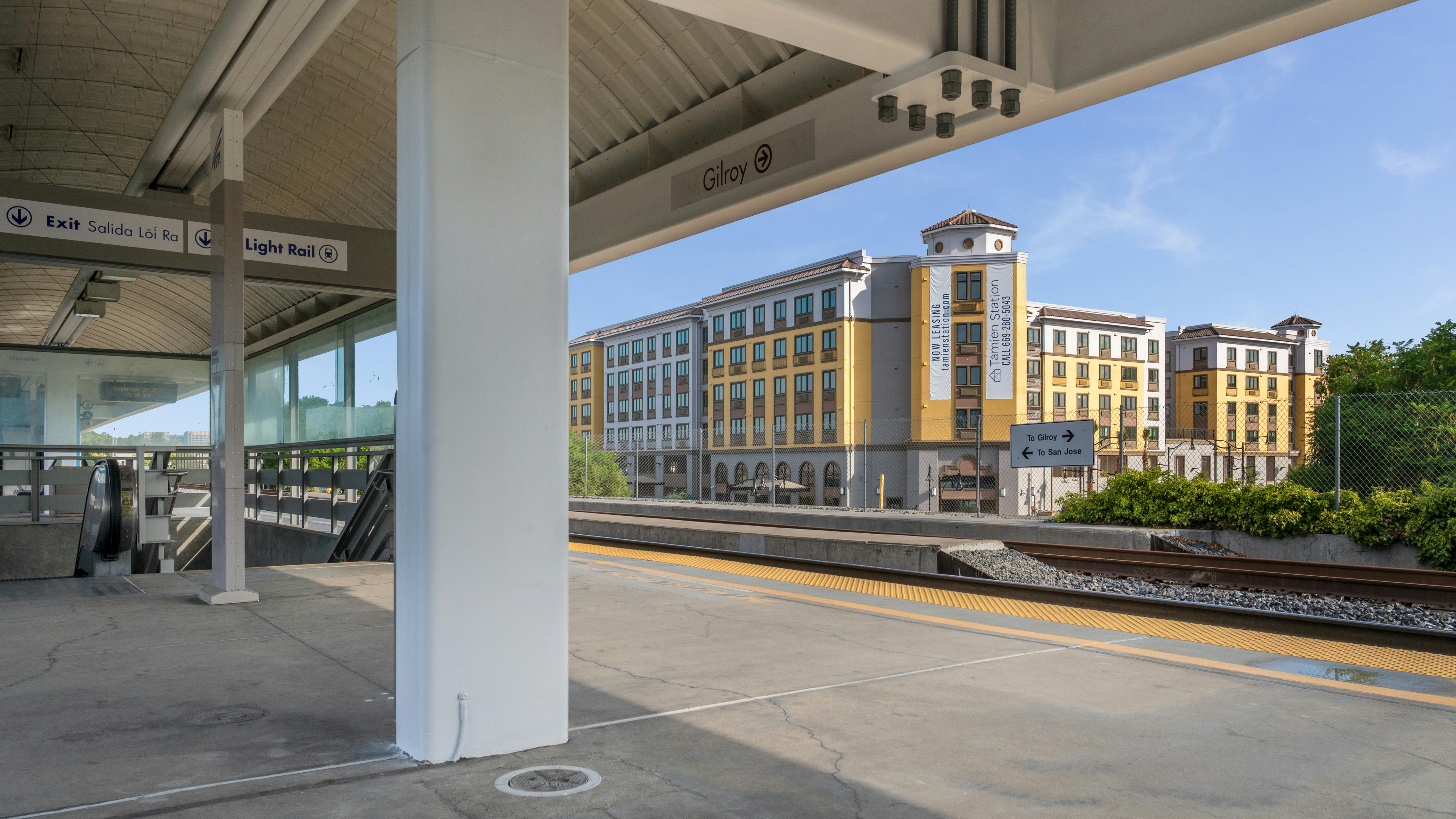 The image shows an exterior shot of the new building taken from a nearby transit platform.
