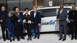 Pace and Metra leaders stand in front of a VanGo van with jumbo scissors. Pace and Metra leaders stand in front of a VanGo van with jumbo scissors.