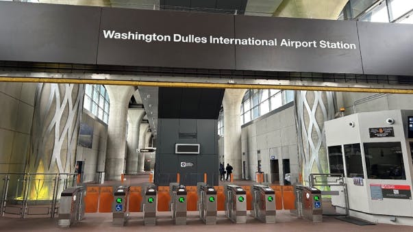 The image displays turnstiles at the Washington Dulles International Airport Station.