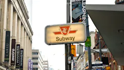 A TTC subway sign rests on a pole. A TTC subway sign rests on a pole.