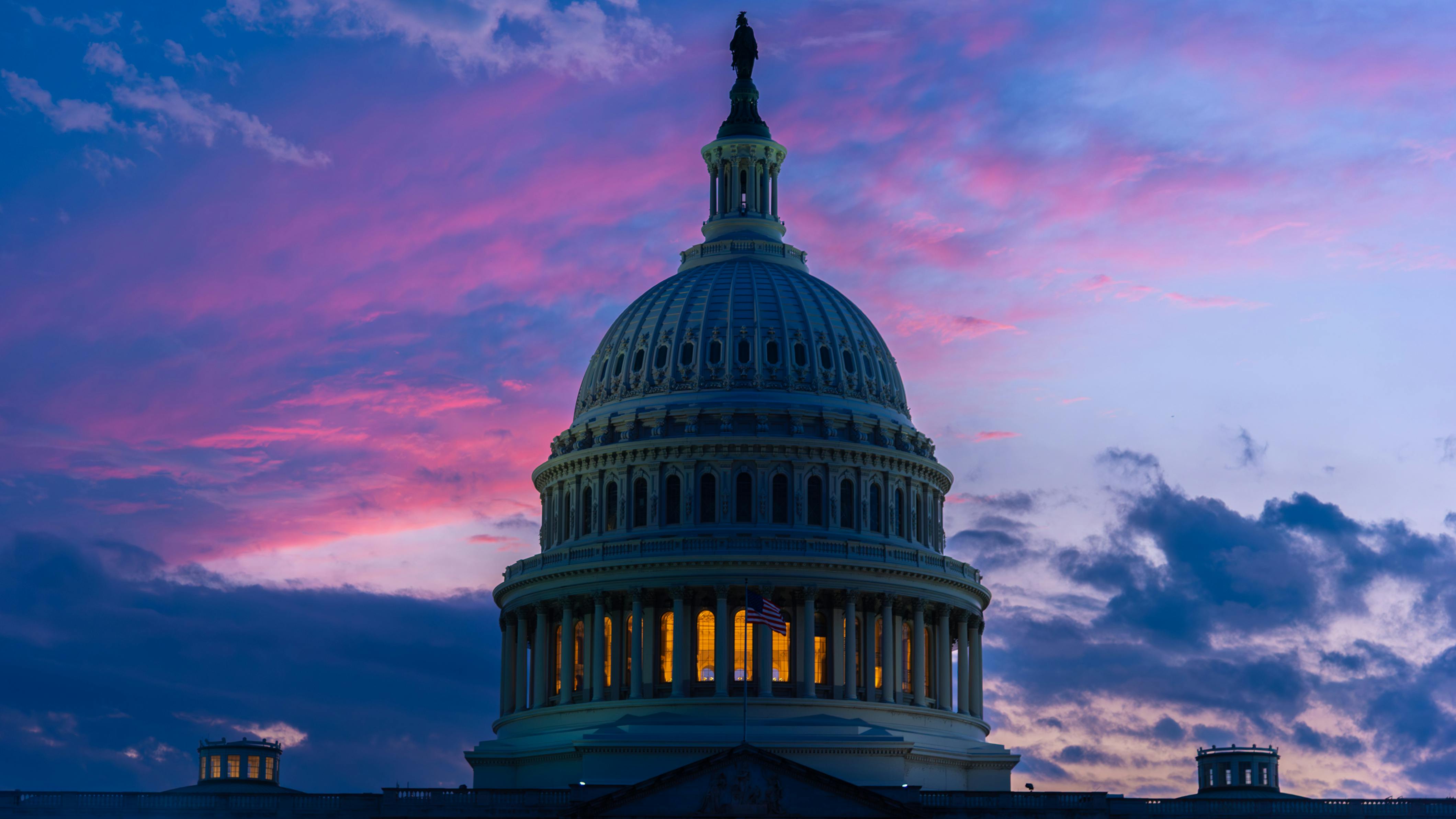 The image shows the U.S. Capitol Dome at sunset.