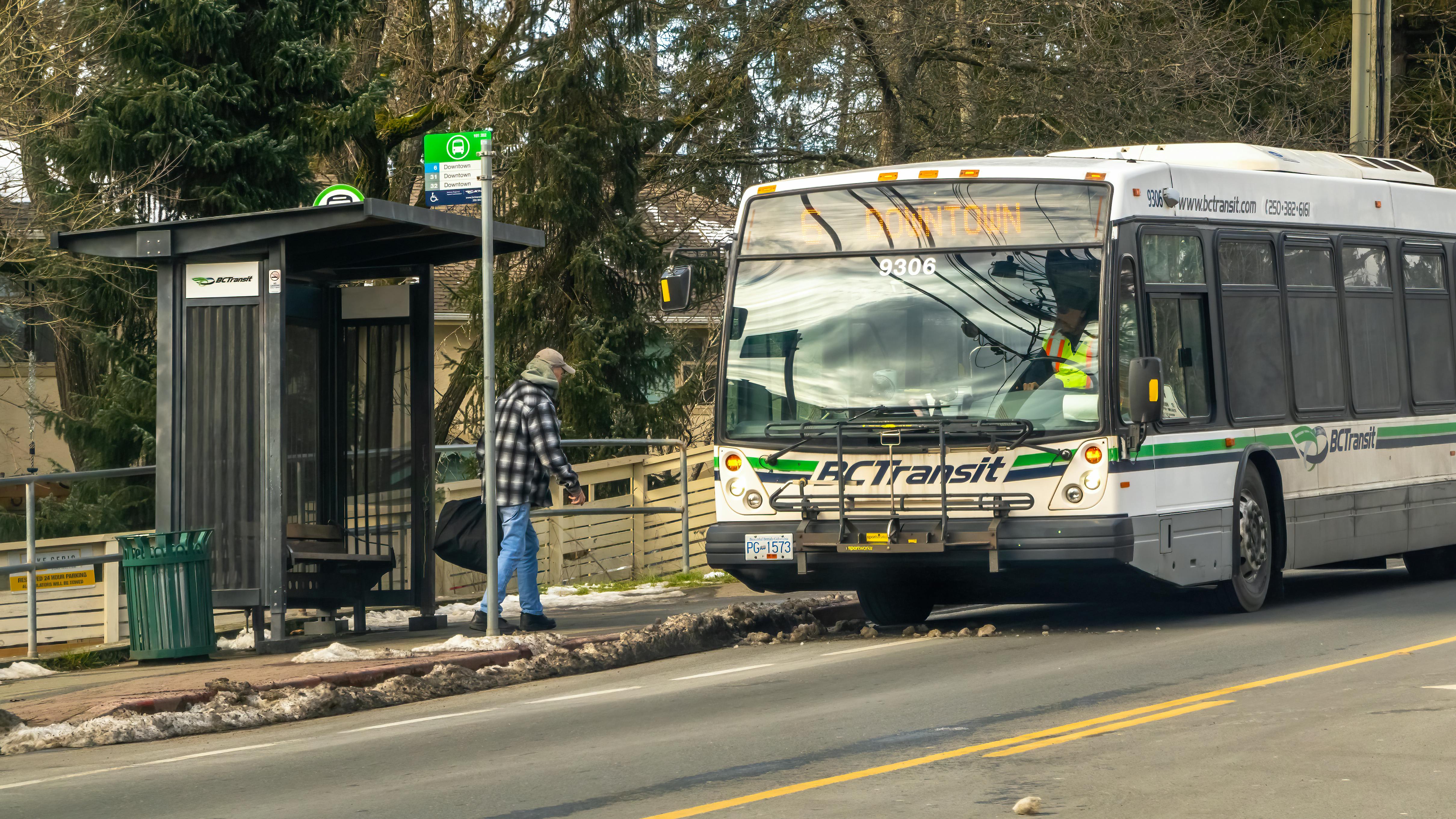 A man boards a BC Transit bus.