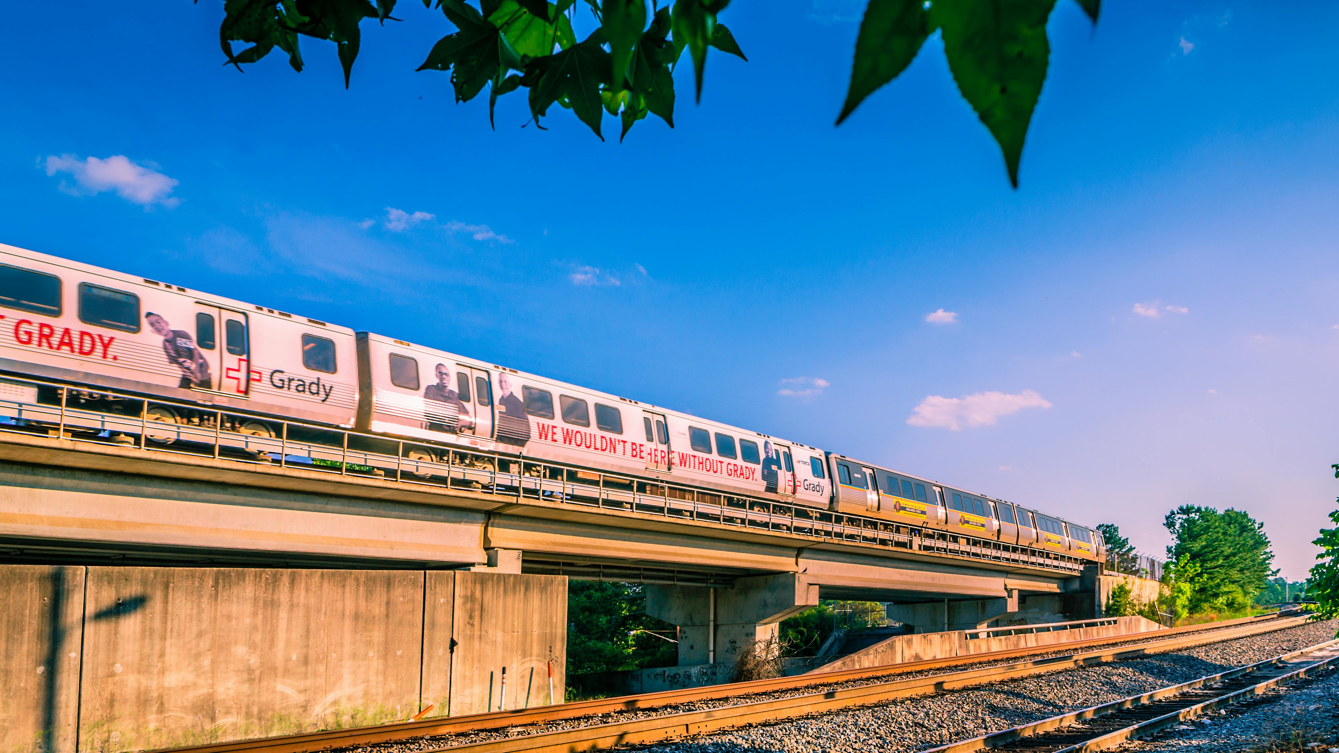 A MARTA train drives down an elevated track.