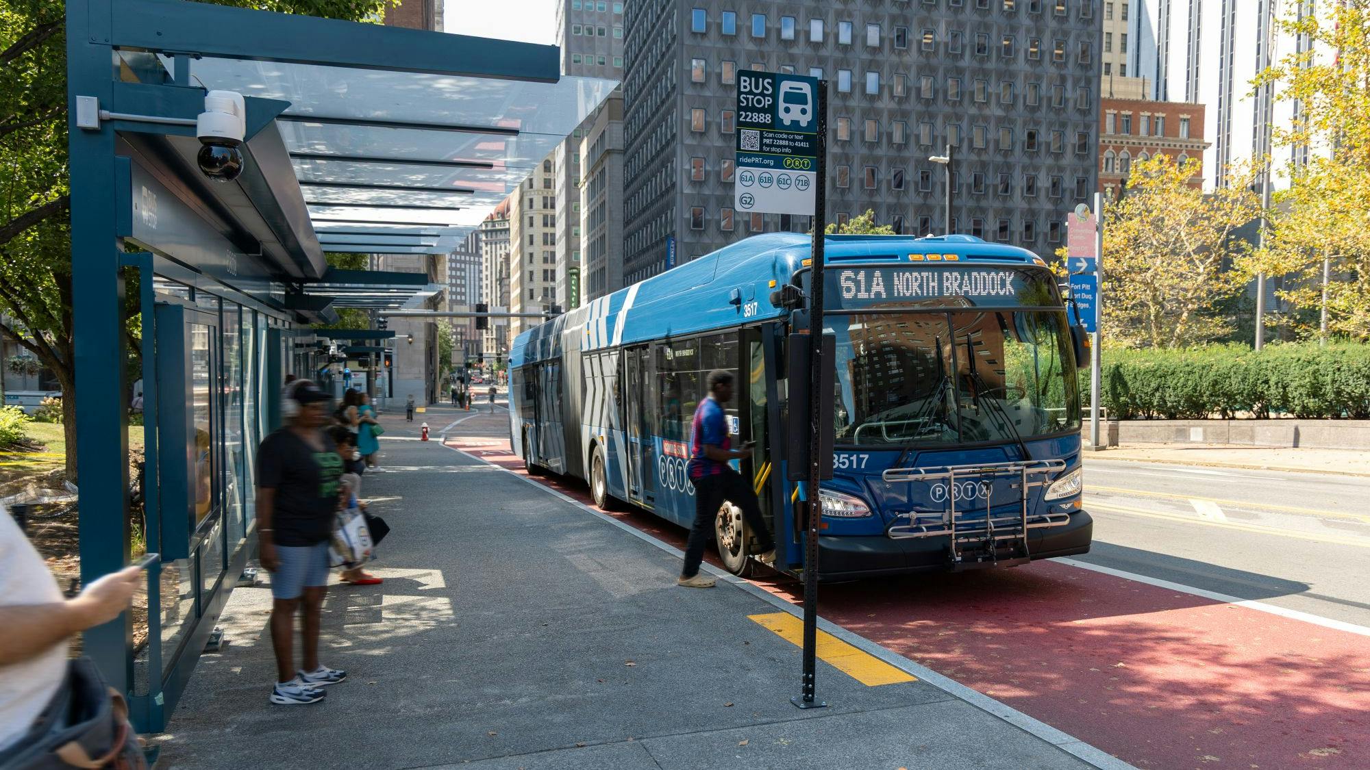 A rider boarding the front door of a PRTX bus at the University Line's Steel Plaza Station in downtown Pittsburgh in August 2025.