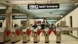 The image shows the old fare gates at a BART station enterance. The image shows the old fare gates at a BART station enterance.