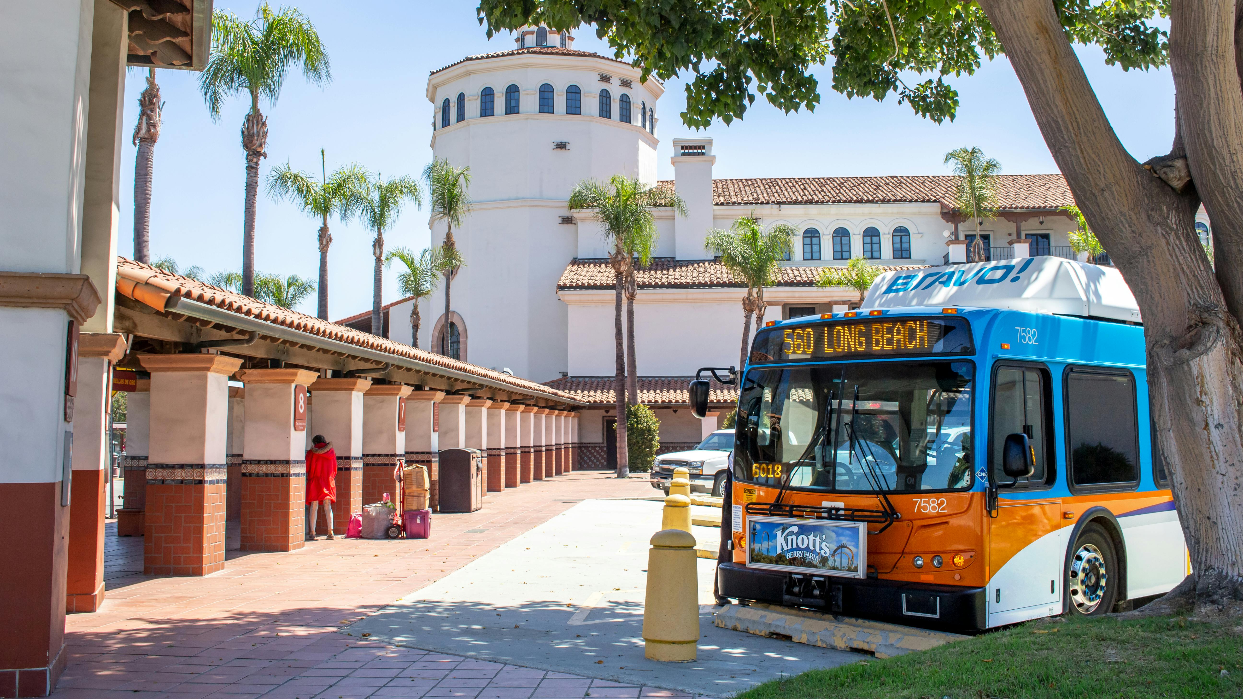 An OCTA bus sits parked outside of the Santa Ana Transit Center.