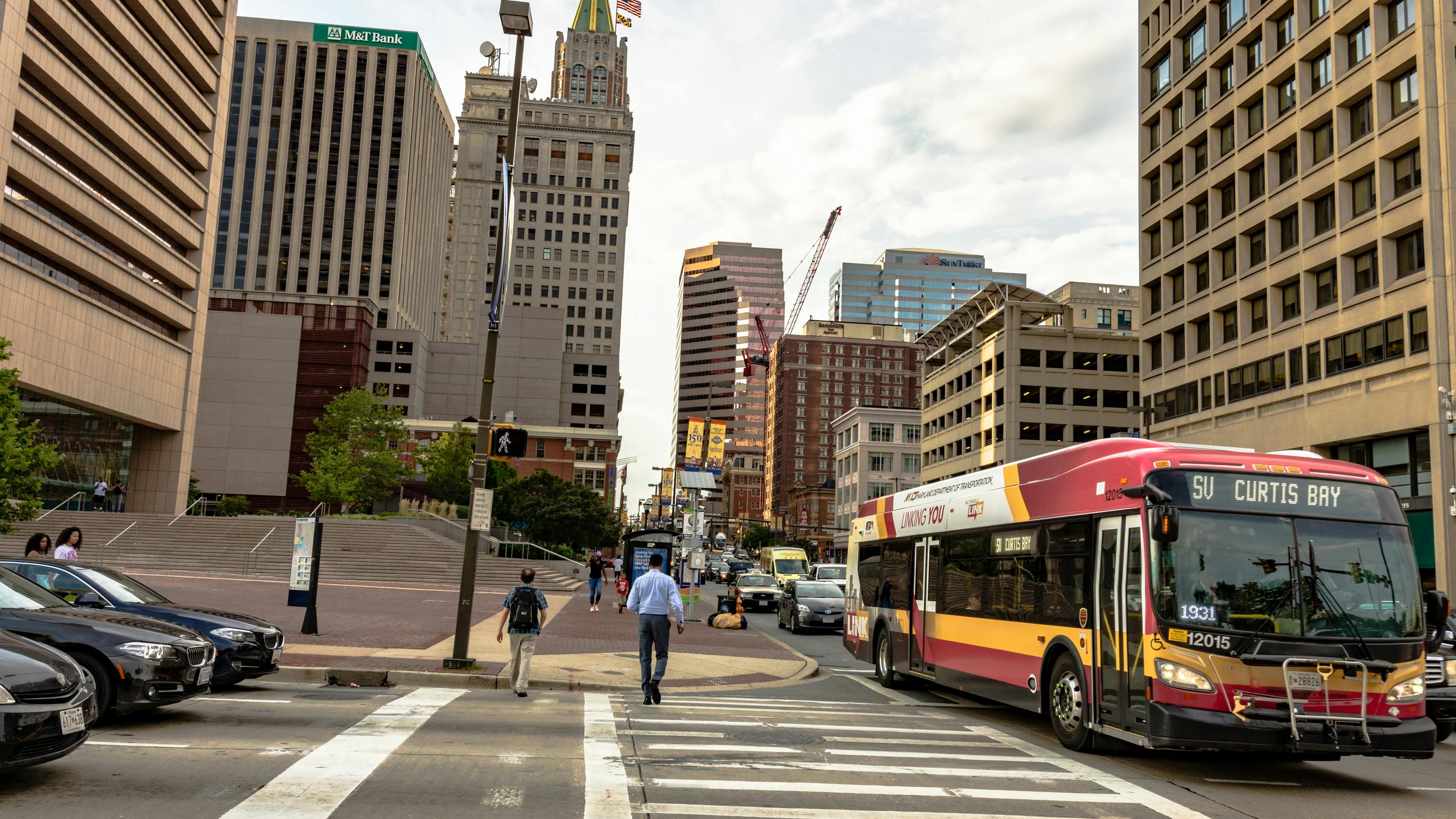 Traffic and pedestrians in downtown Baltimore near the city center.