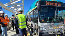 Project workers examine how a bus lines up to the new platforms. Project workers examine how a bus lines up to the new platforms.