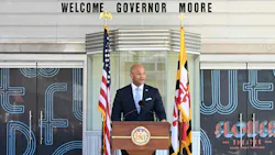 Maryland governor Wes Moore stands at a podium speaking. Maryland governor Wes Moore stands at a podium speaking.