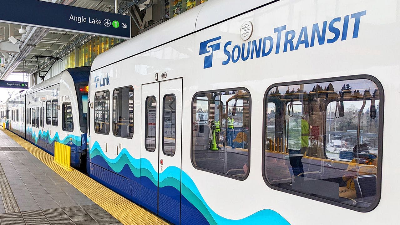 A Sound Transit rail vehicle sits at a station.