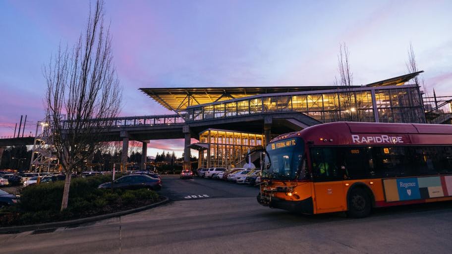A RapidRide bus drives through dusk.