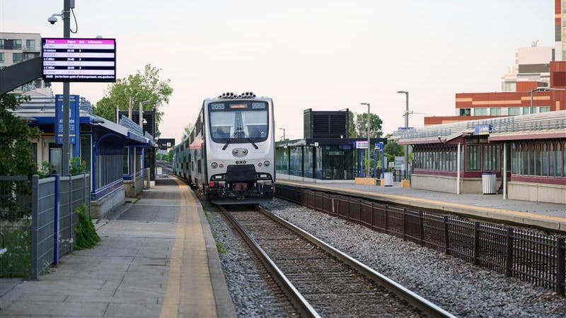 An exo trains sits at a station.
