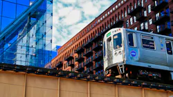 A CTA train is pictured from a lower angle moving along an elevated track. A CTA train is pictured from a lower angle moving along an elevated track.