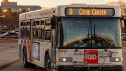 A Denver RTD bus drives down the street in the evening. A Denver RTD bus drives down the street in the evening.