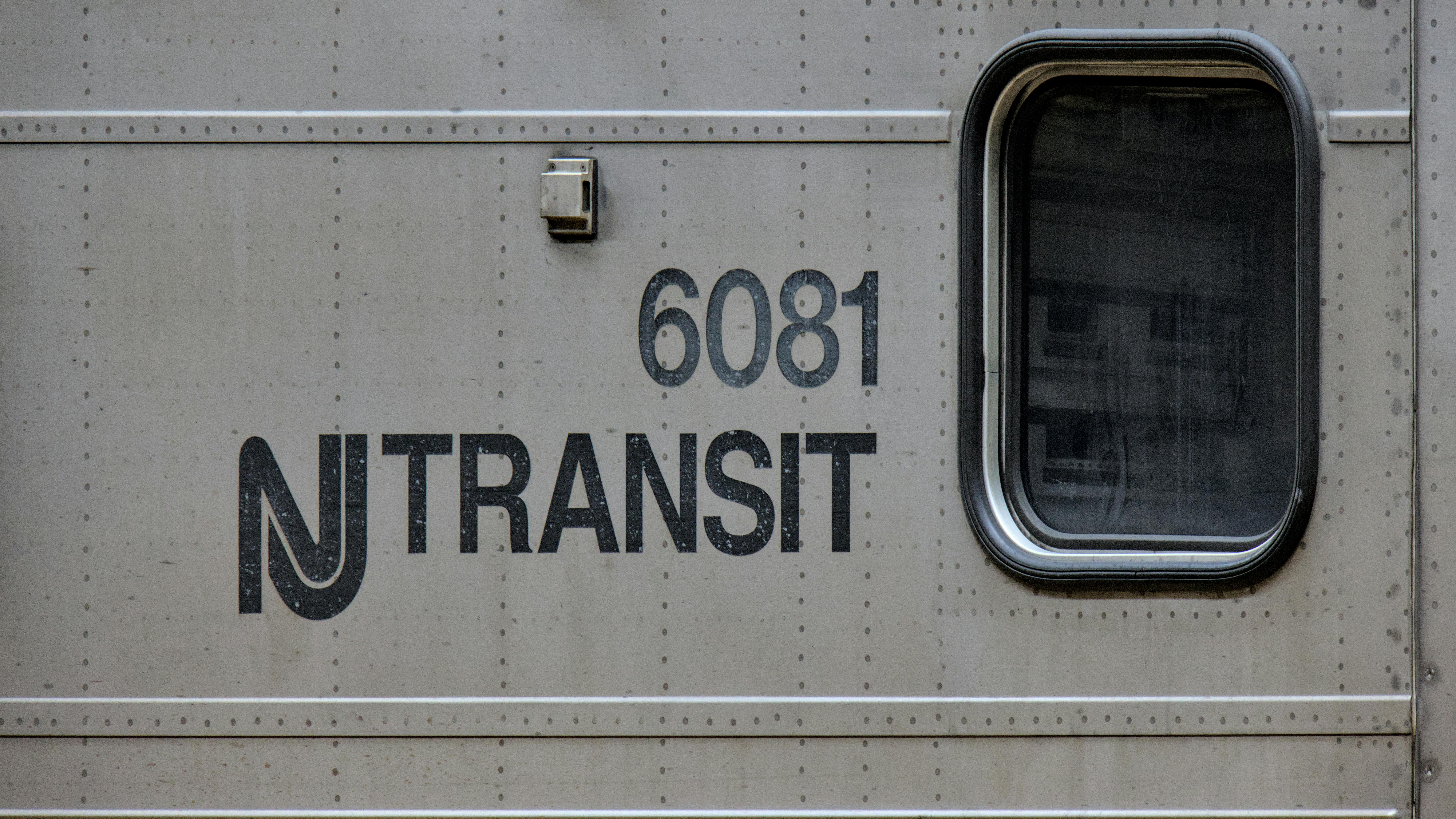 The NJ Transit logo appears on the side of of one of its trains.