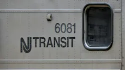The NJ Transit logo appears on the side of of one of its trains. The NJ Transit logo appears on the side of of one of its trains.