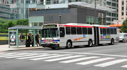 A Southeastern Pennsylvania Transportation Authority articulated bus, Route 33 to 23rd-Venango, stops at a covered bus shelter in downtown Philadelphia as passengers board. The white bus with red and blue striping carries vehicle number 7138. The Comcast Center tower is visible in the background. A Southeastern Pennsylvania Transportation Authority articulated bus, Route 33 to 23rd-Venango, stops at a covered bus shelter in downtown Philadelphia as passengers board. The white bus with red and blue striping carries vehicle number 7138. The Comcast Center tower is visible in the background.