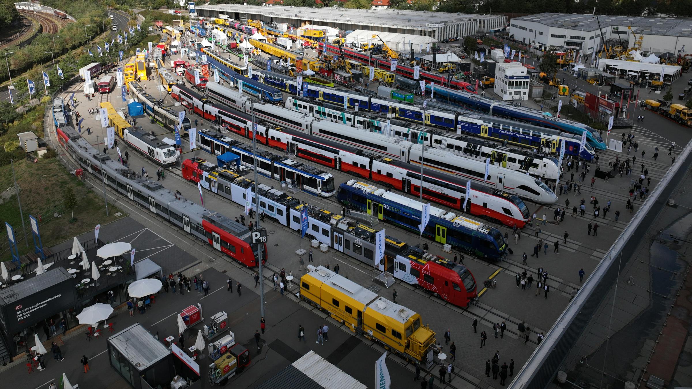 passenger trains line up outside a convention center for attendees to view