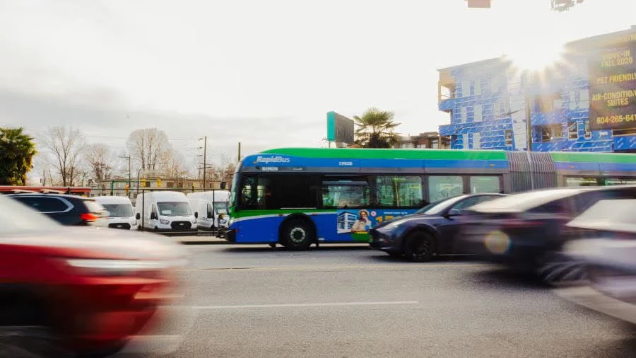 Translink Vehicles A TransLink RapidBus travels through a busy urban intersection in Metro ...