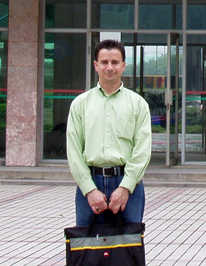 Darren Russell in front of the school where he taught in China