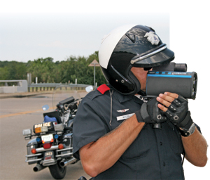 Traffic Officer Mitch Lee of the Grand Prairie (Texas) PD demonstrates the DBC-equipped Laser Tech Ultra Lyte Lidar device, which can calculate accurate measurements between vehicles, both in distance and time.