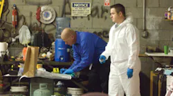 Investigators catalog weapons and evidence at the Phoenix tire center. Investigators catalog weapons and evidence at the Phoenix tire center.