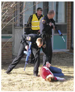 First responders in the Concordia University Wisconsin training check the status of a victim. First responders in the Concordia University Wisconsin training check the status of a victim.