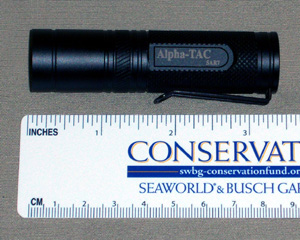 Shown with a ruler to confirm size, the Extreme Beam Alpha Tac is quite a handy package.