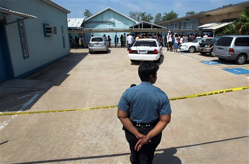 A Houston Independent School District police officer monitors an entrance after a shooting at Ross Elementary school April 19 in Houston.