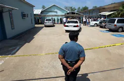 A Houston Independent School District police officer monitors an entrance after a shooting at Ross Elementary school April 19 in Houston. A Houston Independent School District police officer monitors an entrance after a shooting at Ross Elementary school April 19 in Houston.