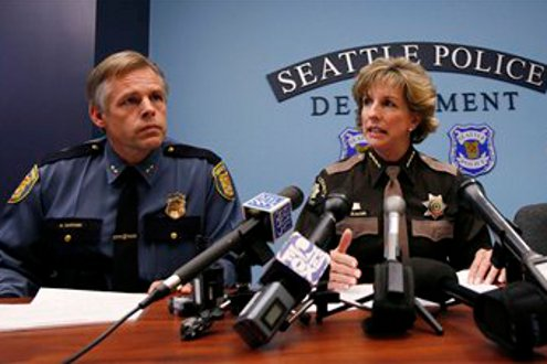 King Count Sheriff Sue Rahr, center, addresses a news conference with Seattle Police Department Assistant Chief Mike Sanford, left.