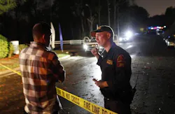 Raleigh police officer J.L. Bloodworth, right, speaks to Jose Arriag Jr. who seeking information about his relatives at Stoney Brook Mobile Home Park, April 16. Raleigh police officer J.L. Bloodworth, right, speaks to Jose Arriag Jr. who seeking information about his relatives at Stoney Brook Mobile Home Park, April 16.