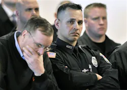 Woburn, Mass., police officers react during the arraignment April 6 in Woburn, Mass. Woburn, Mass., police officers react during the arraignment April 6 in Woburn, Mass.