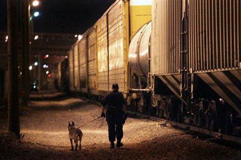 A Mexican locomotive enters a secondary inspection by a Union Pacific Police officer.