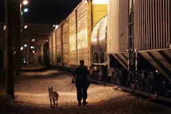 A Mexican locomotive enters a secondary inspection by a Union Pacific Police officer. A Mexican locomotive enters a secondary inspection by a Union Pacific Police officer.